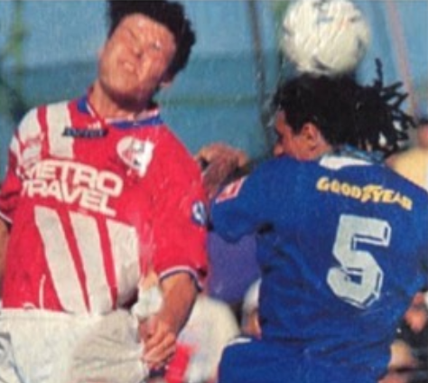 Andy Bernal leaps for a header with Mark Viduka Andy Bernal leaps for a header with Mark Viduka