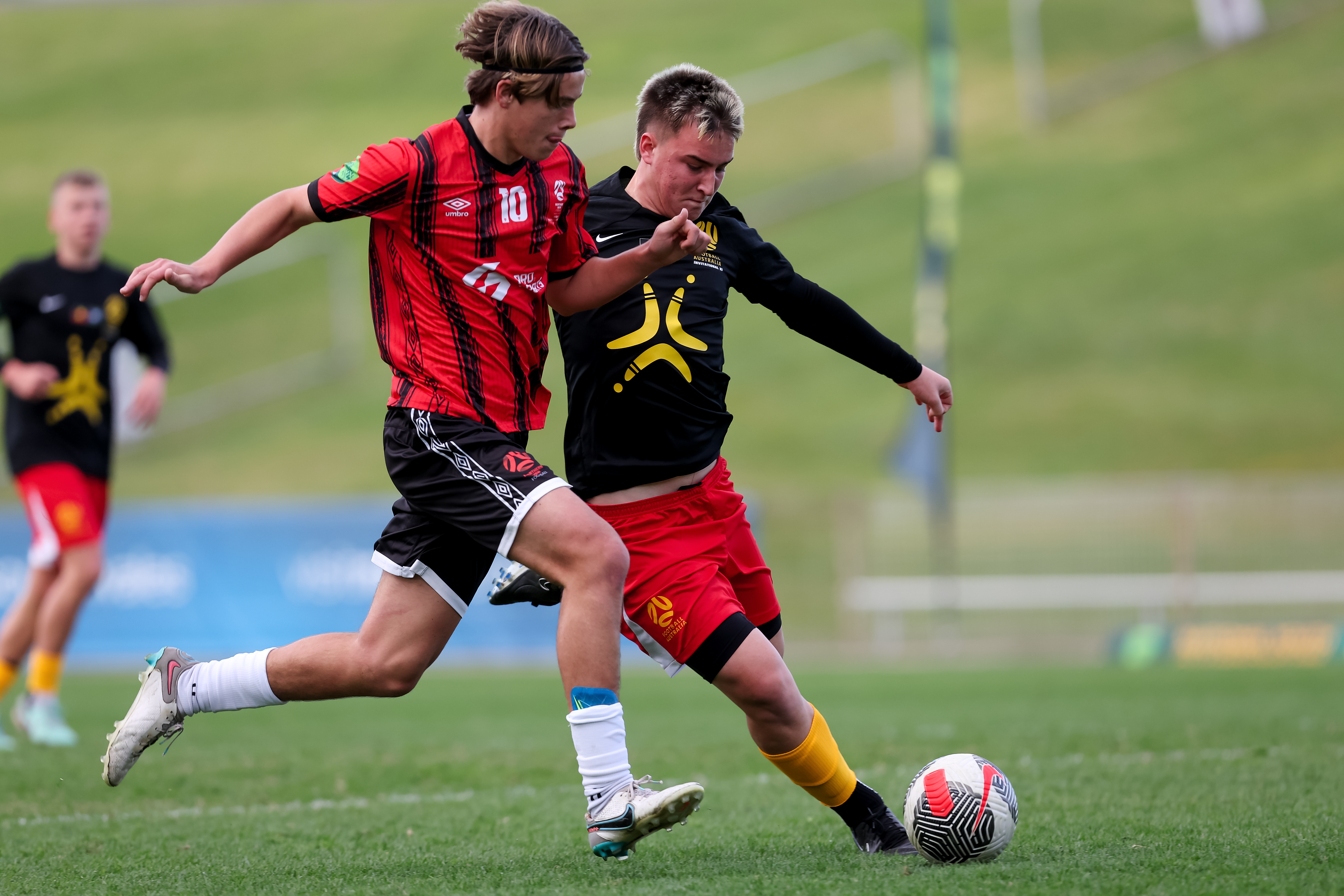 Invitational XI jostles for the ball against Northern NSW