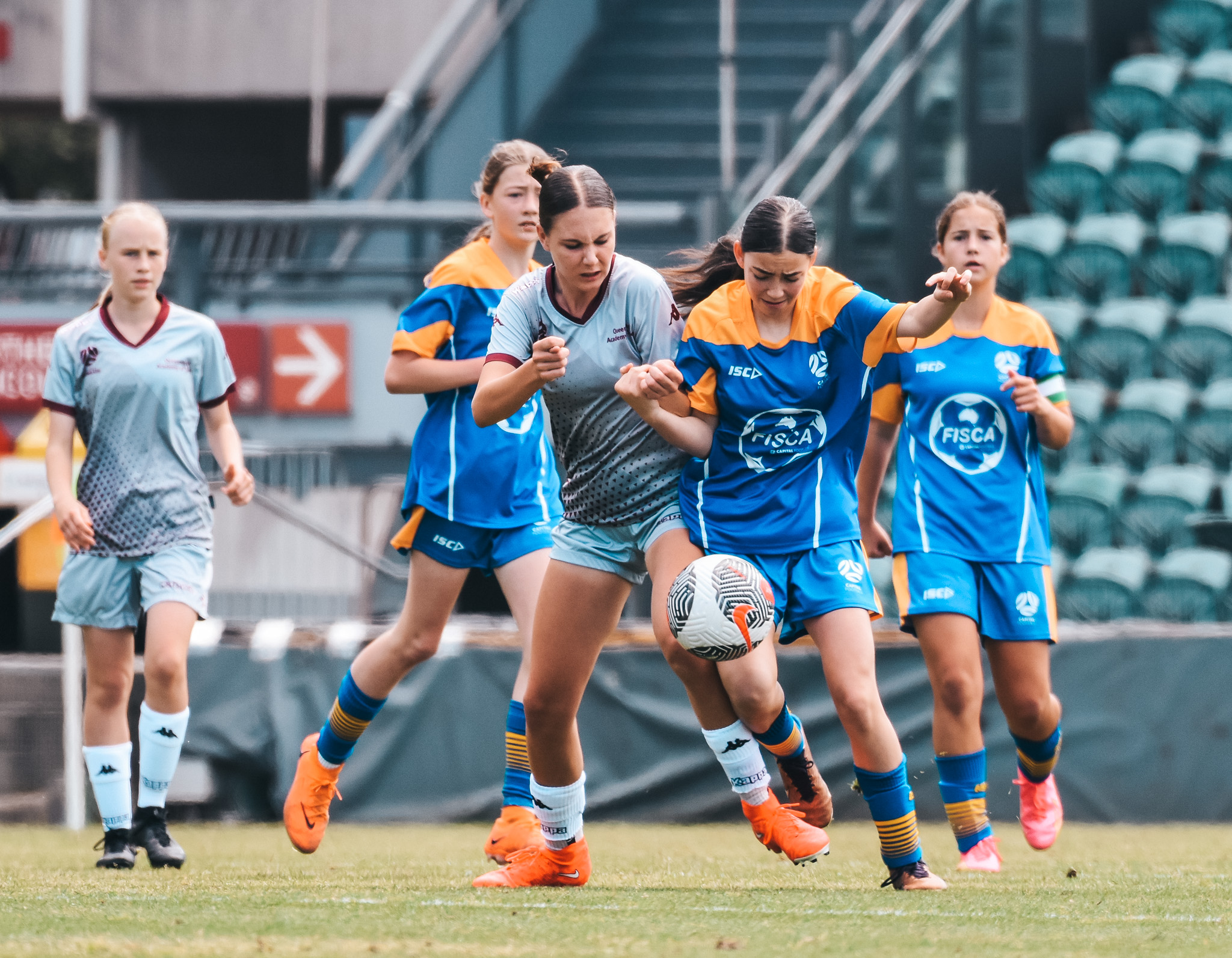 Football Queensland and Capital Football compete for the ball