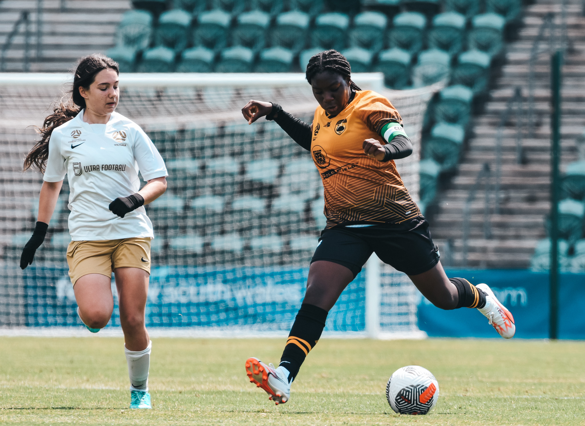 Football West charge down the field with Football Victoria in chase