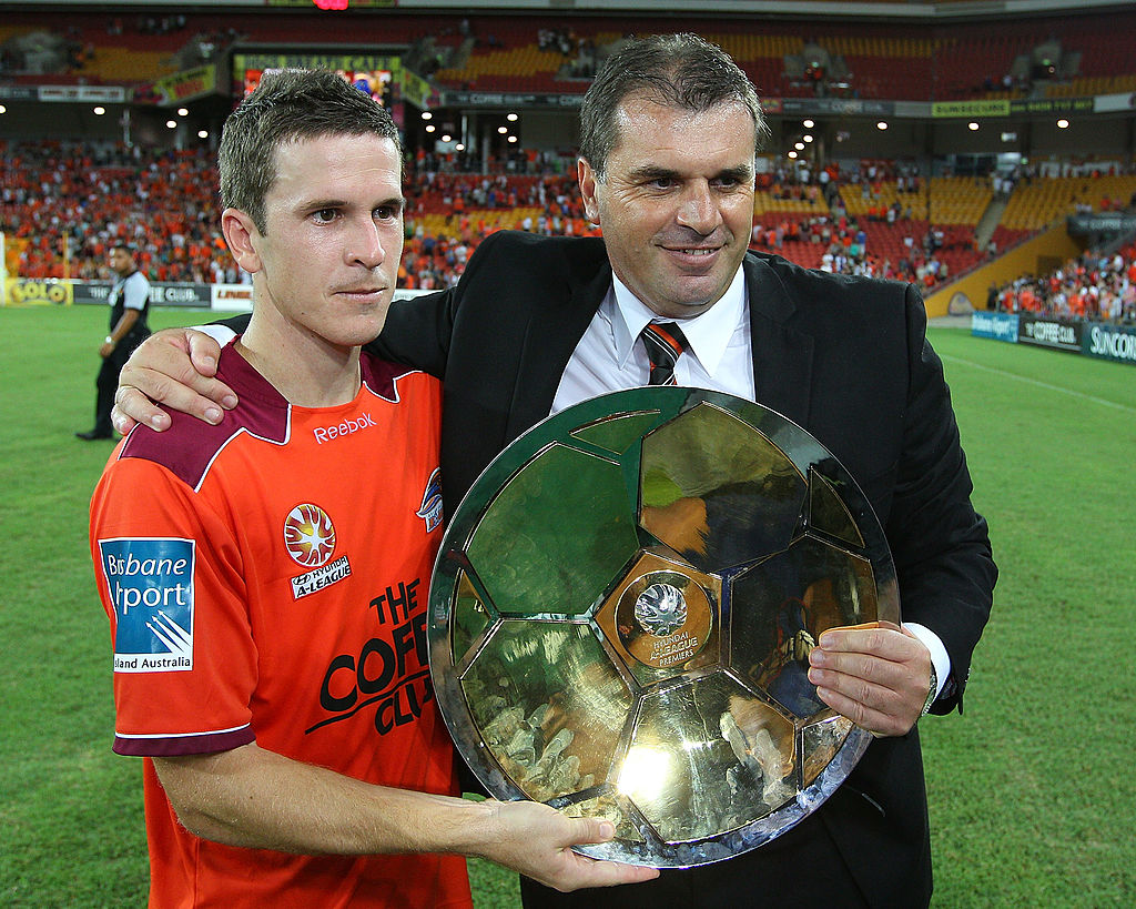 Ange Postecoglou poses with Brisbane Roar captain Matt McKay after winning the A-League Premiership