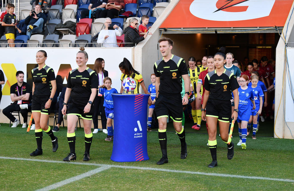 Referees lead the teams out during the round seven A-League Women's match between Adelaide United and Wellington Phoenix at ServiceFM Stadium, on March 28, 2023, in Adelaide, Australia. (Photo by Mark Brake/Getty Images)